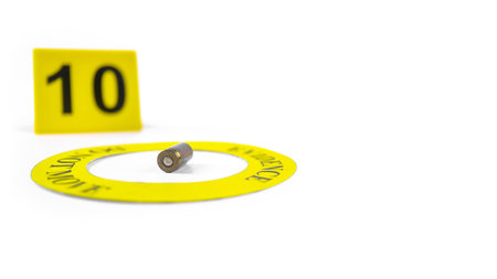 A spent bullet casing placed within a yellow circle, labeled with the text "Evidence, Do Not Move," with a blurred number 10 tag, set against a white background, concept of crime investigation.の写真素材