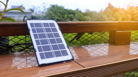 Close up small solar panel designed to power decorative lights along a balcony. The image highlights the compact solar cells, showcasing their functionality eco-friendly energy use.の写真素材