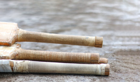 Wooden cricket bat handles resting on a dark surface, symbolizing the concept of physical activity through cricket and the passion of cricket enthusiasts, the sport's role in fitness and recreation.の写真素材