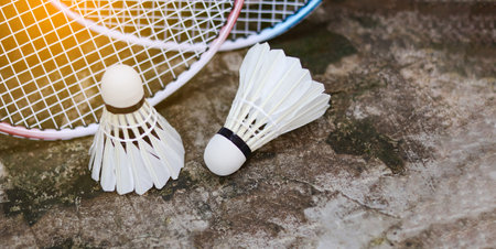 White badminton shuttlecocks and badminton rackets on dark background to enhance doing exercise.の写真素材