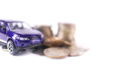 Model car with euro banknotes on white background concept of saving for buying car, car loan and car insurance.の写真素材