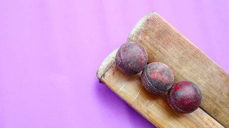 A broken cricket bat and damaged ball, evoking the concept of resilience in sports, reflecting the wear and tear of dedication and the journey athletes undertake in their pursuit of excellence.の写真素材