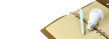 White light bulb on an open notebook, symbolizing creativity, innovation, inspiration and new ideas.の写真素材