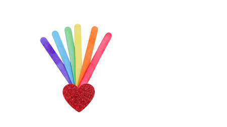 Rainbow colored ice cream sticks held in hand, symbolizing LGBTQ+ pride, diversity, and inclusion. A simple yet powerful representation of love and equality.の写真素材
