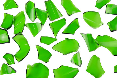 Sharp and jagged pieces of broken green glass cut out on a white background, symbolizing fragility and caution.の写真素材