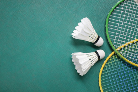 Badminton racket and white shuttlecock on green badminton courtの写真素材