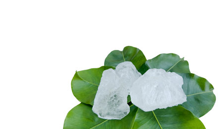 Crystal clear alum cubes or Potassium alum in on green leaves chemical compound substance concept...