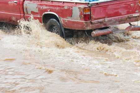Dynamic shot capturing the struggle and movement through floodwaters, symbolizing resilience.