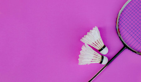 Shuttlecock and racket arranged on a Purple background. Concept: Freshness, vitality, and movement...