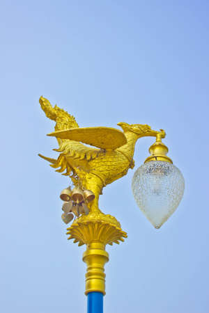 Thai Style Golden Swan Lamp with blue skyの写真素材
