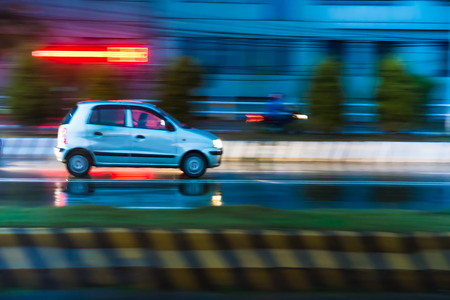 Night road silver white car / taxi speedの写真素材
