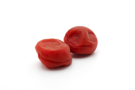 Japanese salt plum or pickled plum on white backgroundの写真素材