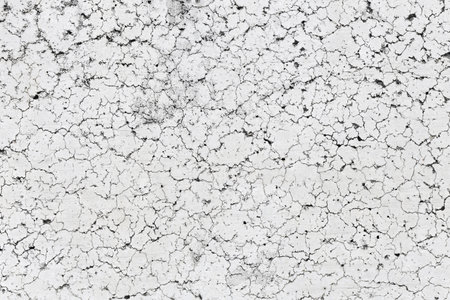 Cracked white paint on the wall. Abstract background and texture for design.の写真素材