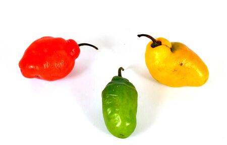 colorful hot chilli pepper on white background - raw food ingredient conceptの写真素材