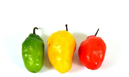 colorful hot chilli pepper on white background - raw food ingredient conceptの写真素材