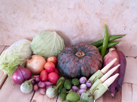 Many types of vegetables set together on a wooden table.の写真素材