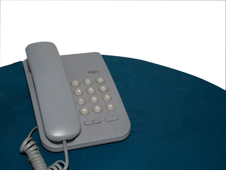 Home phone, placed on a table covered with cloth.の写真素材