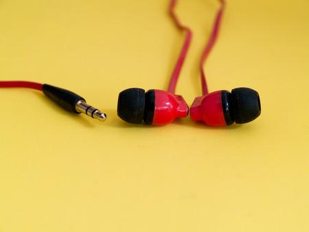 Speakers, headphones, red on a yellow background.