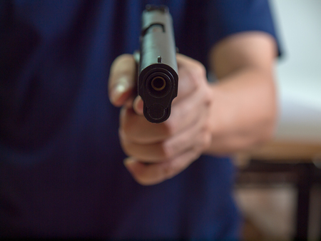 Man with gun, gangster, focus on the gun