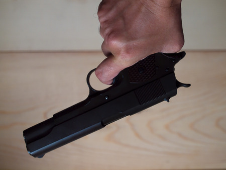 man with a gun ready to shoot focus on the weapon