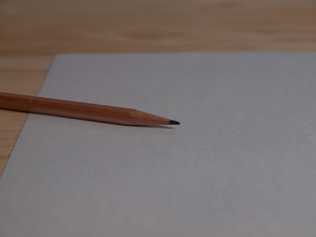 paper and pencils ,Placed on a wooden floor.