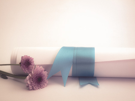 Diploma tied with a blue ribbon ,Put on a white background. Image vintageの写真素材
