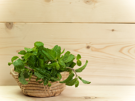 Mint leaves , Placed on a wooden table.(picture with space for text)の写真素材