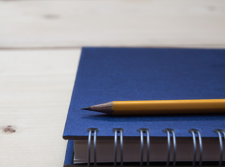 Pencil and book on wooden table,の写真素材