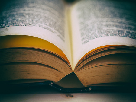 Open book on a wooden table , Vintage old books.の写真素材