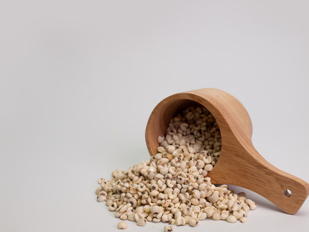 millet ,Placed on a wooden spoon on brown wood. (picture with space for text)の写真素材