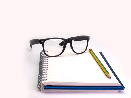 Pencil , book and glasses , Placed on a white background. (Space for your text)の写真素材