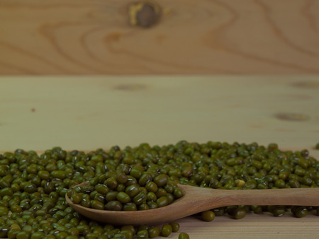 Green bean or mung bean Placed on a wooden floor. (with text space)の写真素材