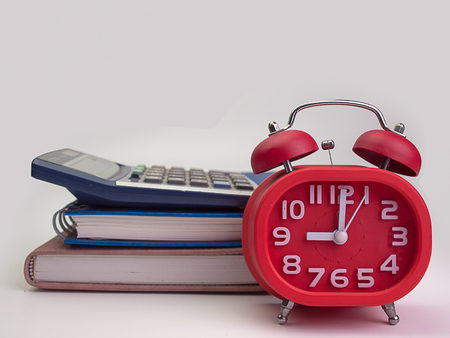 Book and clock   and  calculator  on white background.  education.の写真素材