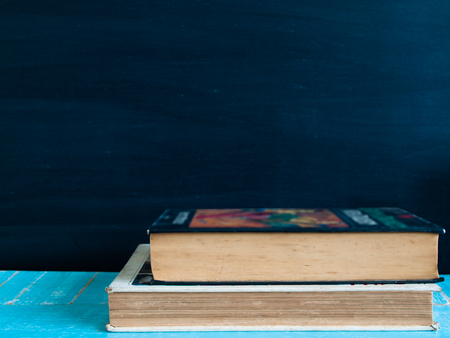 Blackboard and  books , on the table in the classroom. (vintage)の写真素材