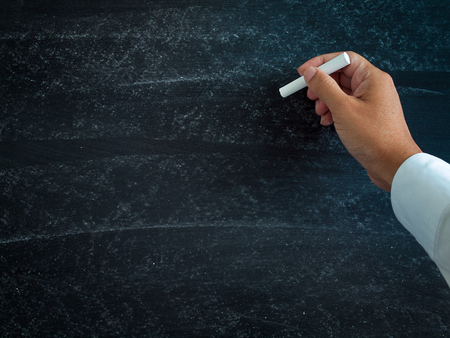 Chalk on a blackboard , with man handwriting for background.texture for add text or graphic design.の写真素材
