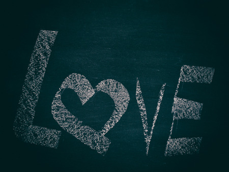 Love symbol on the blackboard. The concept of love.