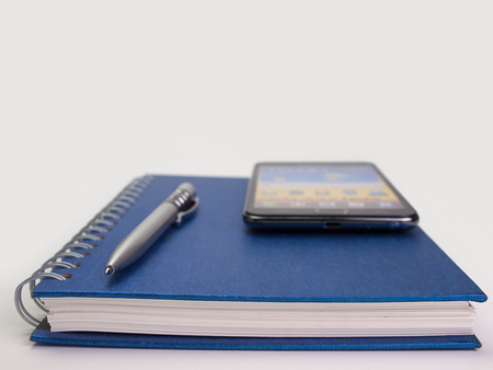 pen and  book, placed on a white background.