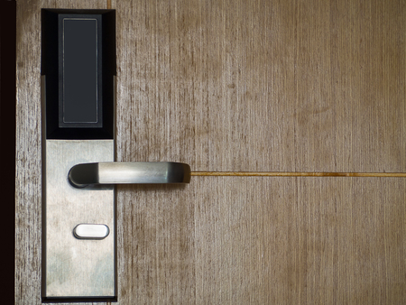Wooden open door with silver metal handle ,Security.の写真素材