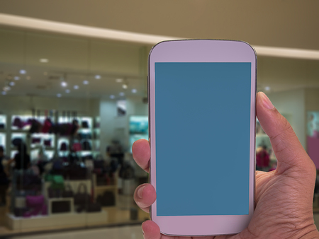 Smart phone online shopping , Shopping center in background.の写真素材