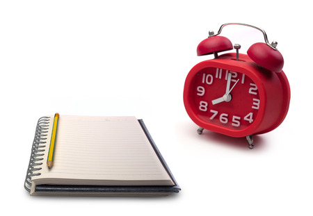 Notebooks and alarm clock on white background. (with free space for text)の写真素材