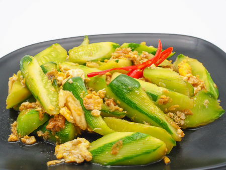 (Close up) Cucuber stir fried with egg and pork. isolated on white background.の写真素材