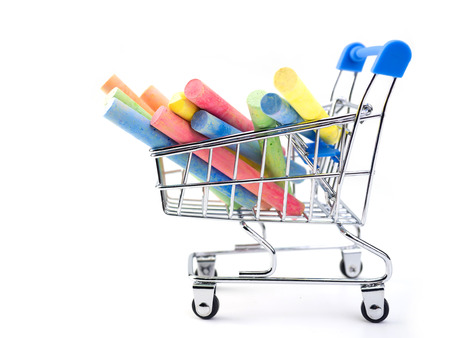 colorful chalk on chrome shopping cart. (education concept)の写真素材
