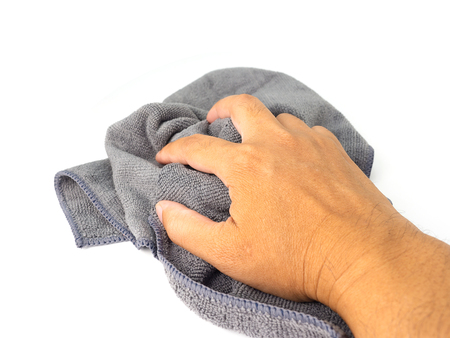 male hand holding microfiber cleaning cloth , on white background.
