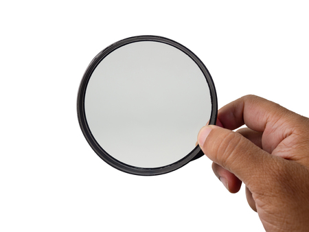 Hand holding magnifying glass isolated on white background. (This has clipping path)の写真素材