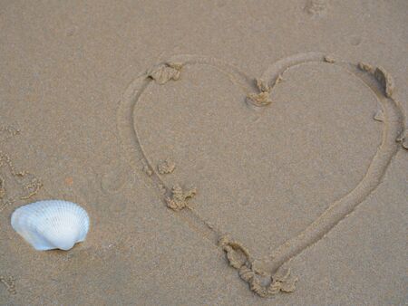 Sand surface and heart shape , beach background. (with free space for text)