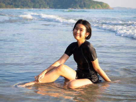Happy teenage girl having fun in the sea.の写真素材
