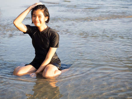 Happy teenage girl having fun in the sea.の写真素材