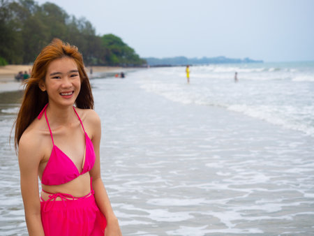 young girl sitting on the beach. by sea. tropical beach. summer style.の写真素材