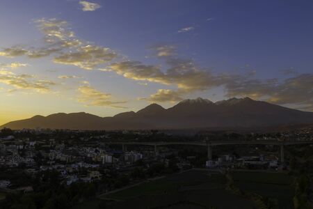 View of the Arequipa outer neighborhoods with the mountains of Chachani volcano as backgroundの写真素材