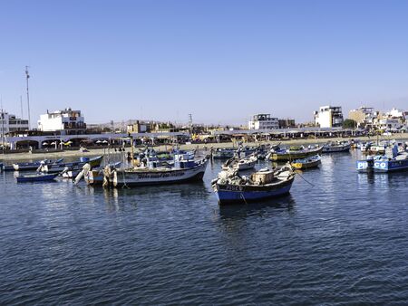 Fishing boats anchored in Paracas pier, in front of Paracas National Reserve, Pisco region, Peruの写真素材